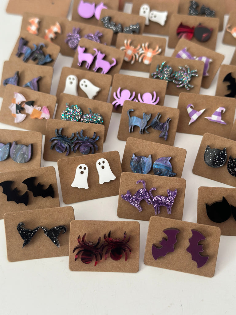 Collection of Halloween-themed earrings on display cards.