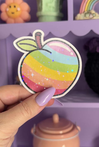 This peach is proud of the LGBTQiIA+ community so I had to make a peachy pride sticker to show off!&nbsp;&nbsp;

You're peachy just the way you are and this cute sparkly hand drawn peach is a fun addition to your Pride Sticker Collection!