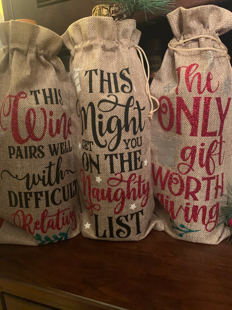 'Tis the season to get tipsy (responsibly) so why not make your gift extra special with a fun wine bag!  Handmade with red, green, white and silver glitter that sparkles like Christmas Lights! Available in red and burlap. 