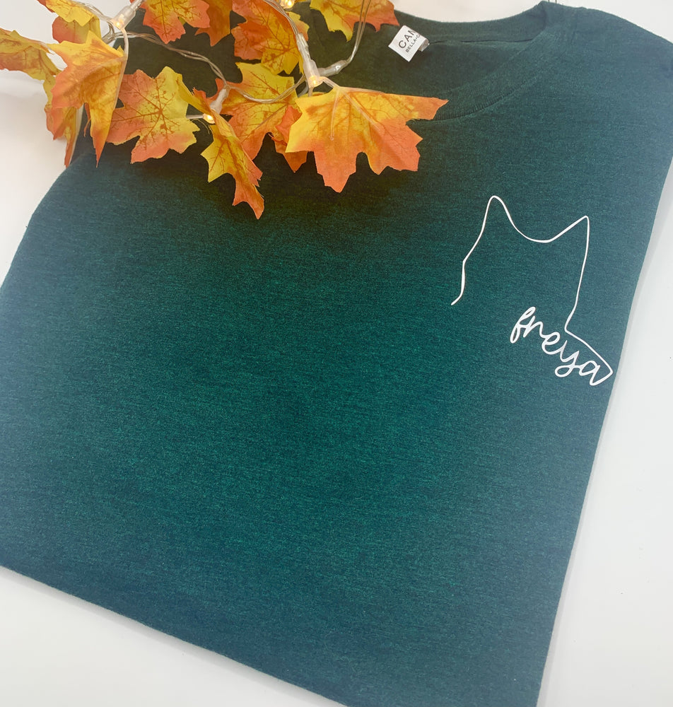 
            
                Load image into Gallery viewer, Custom pet outline with name on chest pocket of a tshirt
            
        