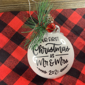 Our First Christmas as Mr. & Mrs. 2021 White Glitter ornament with black lettering and greenery adornments for a keepsake ornament!